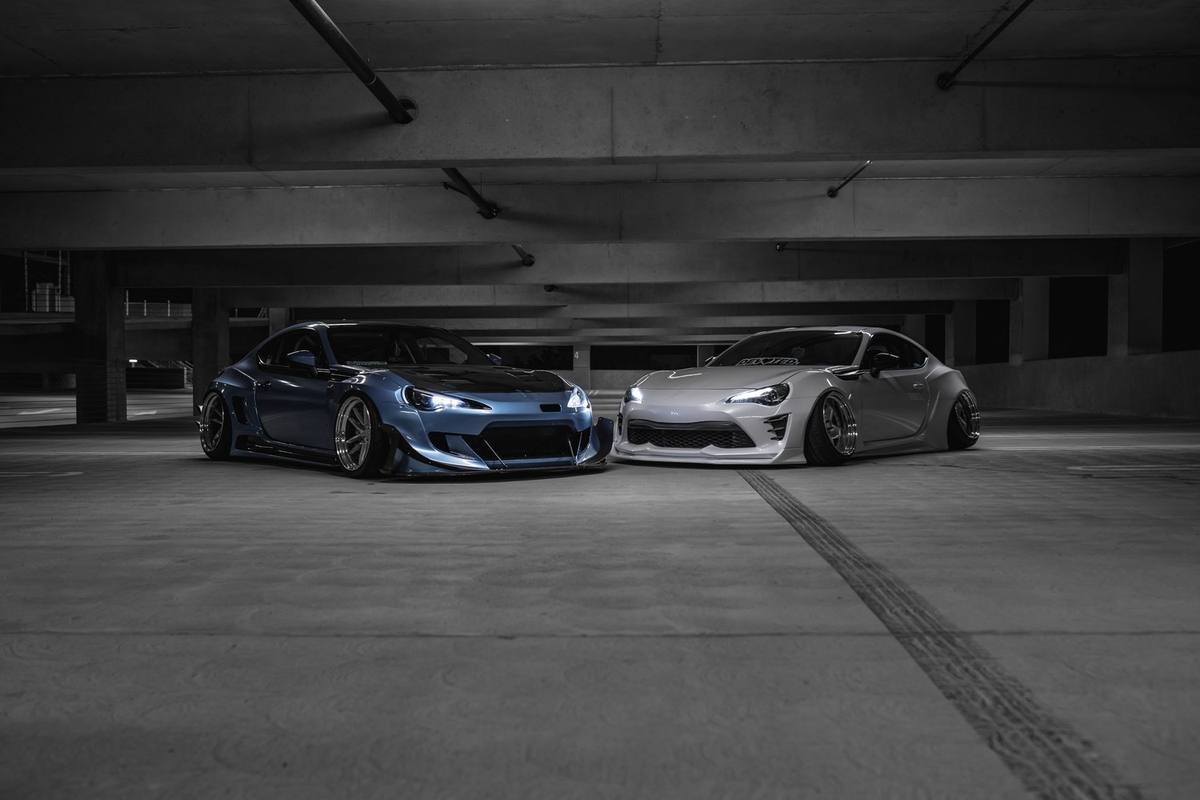 Three cars lined up in a parking garage