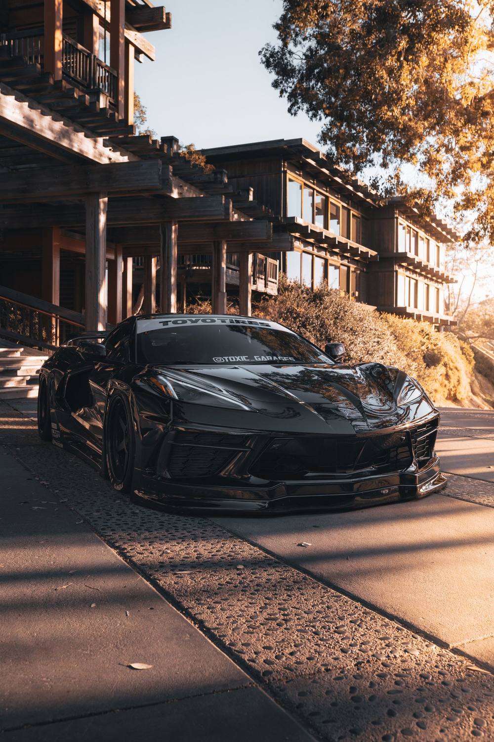 Black C8 Corvette on a resort walkway
