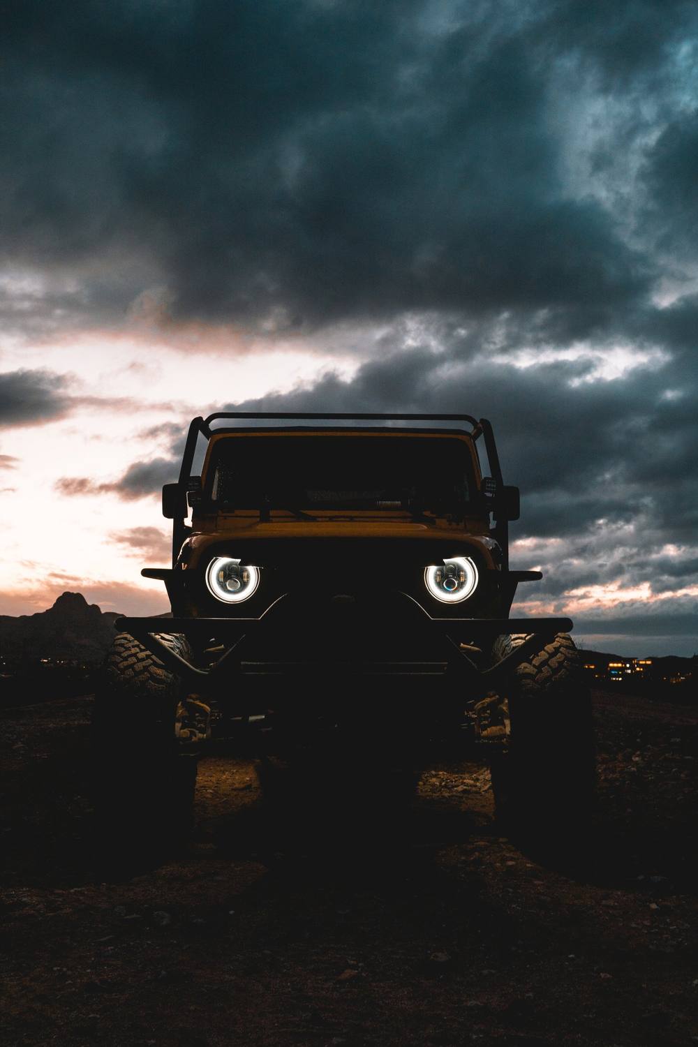 Lifted Jeep under storm clouds