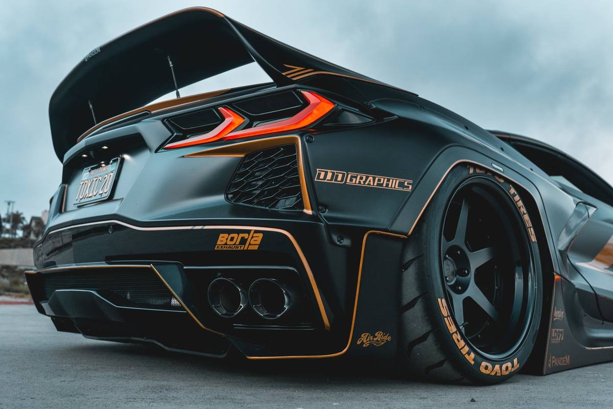Widebody car with orange livery, rear three-quarter