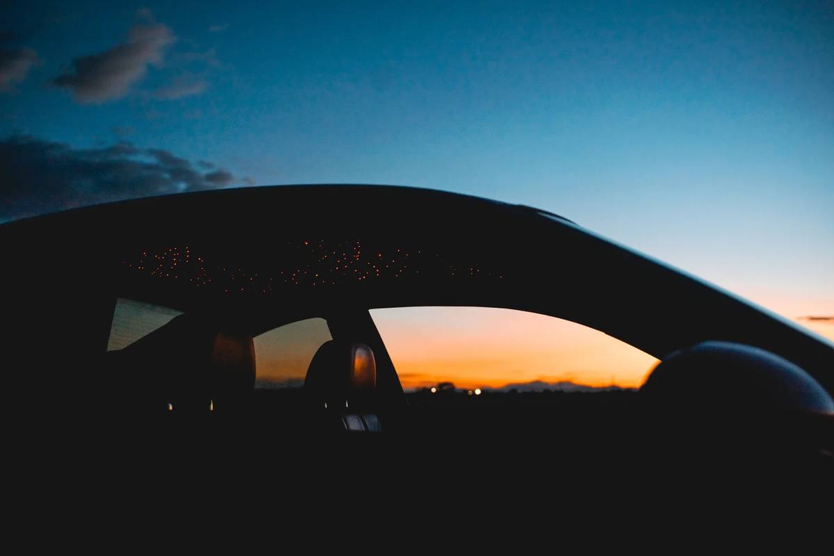 Car silhouette against a twilight sky