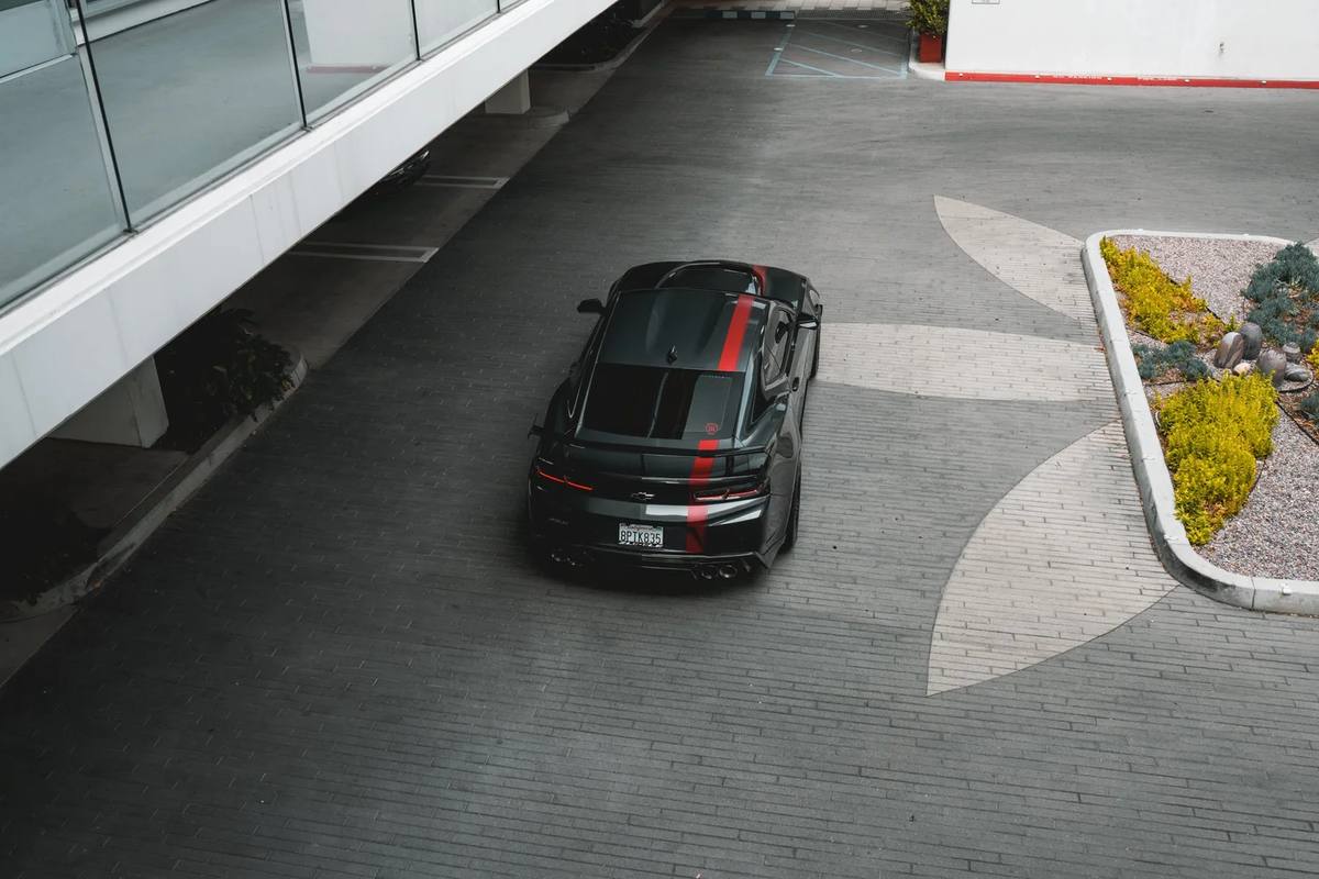 Overhead shot of a black car in a parking lot