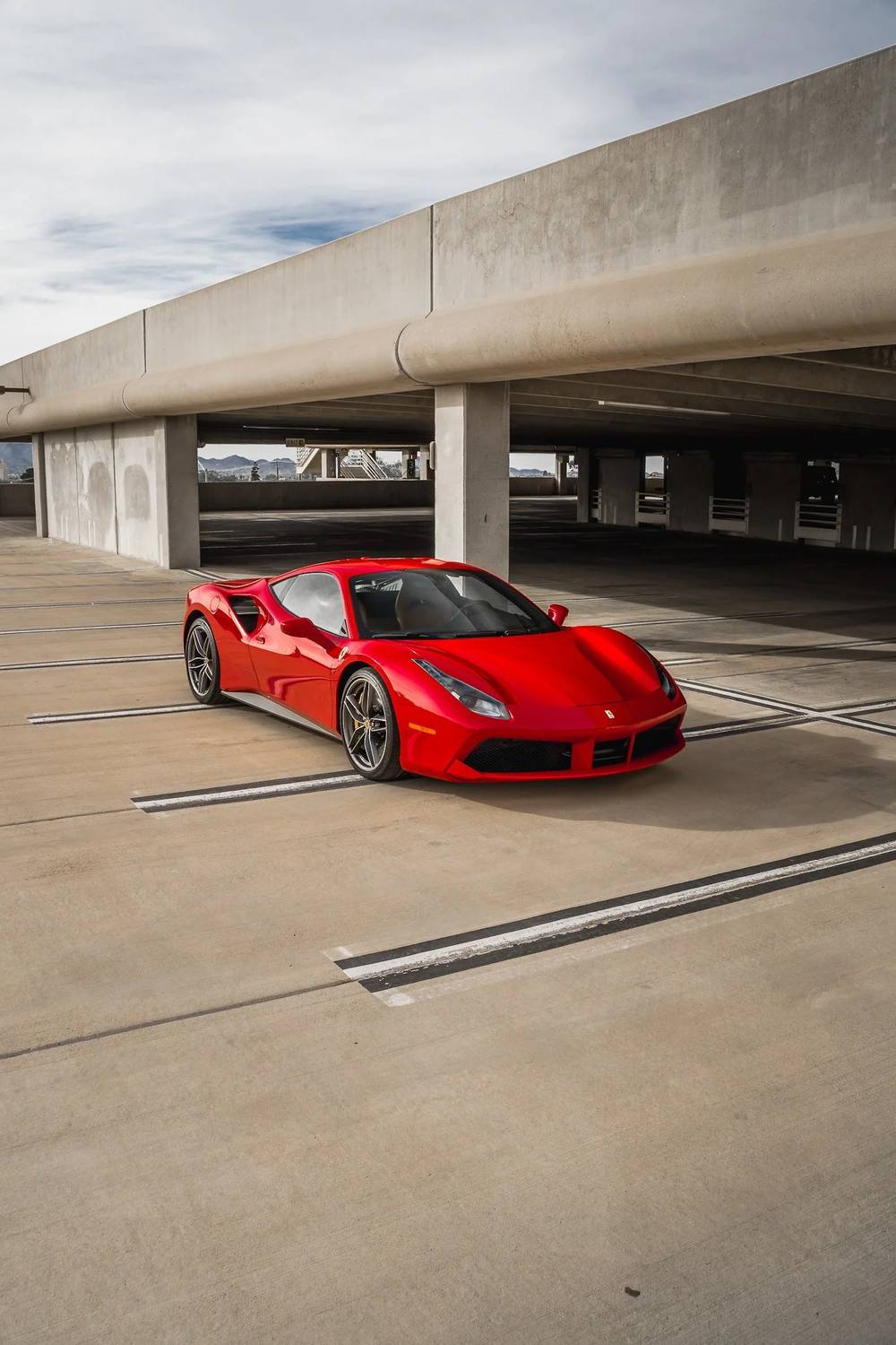 Red Ferrari 488 in a parking garage