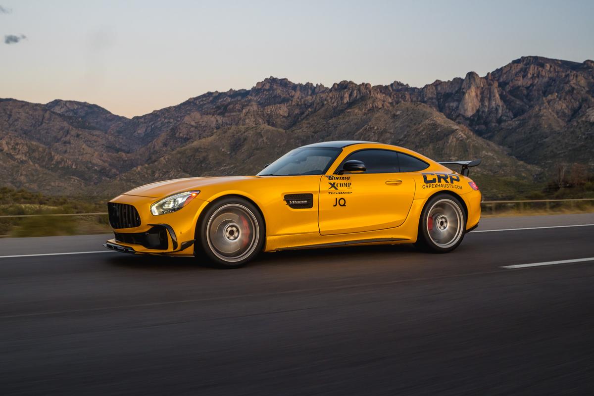 Yellow Mercedes-AMG GT rolling shot with Arizona mountains behind